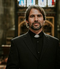 Christian priest standing by the altar