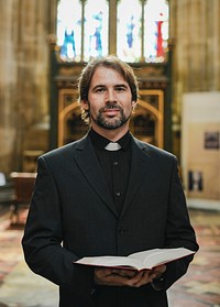 Christian priest standing by the altar