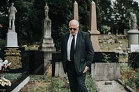 Old man mourning at the graveyard