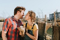 Couple volunteering at a sanctuary for pigs