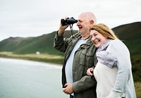 Happy senior couple enjoying with a pair of binoculars