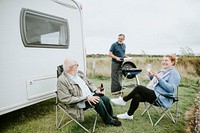 Senior people enjoying outside a trailer
