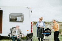 Elderly woman grilling delicious meat