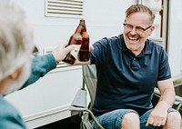 Happy senior men clinking bottle beers