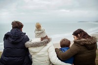 Happy family sitting by the beach