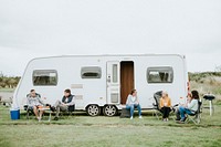 Group of people sitting outside a trailer park