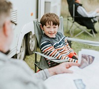 Happy young boy sitting with his grandfather