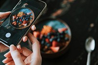 Blogger capturing a healthy breakfast photo to post online