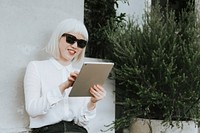 Cool albino woman working on a digital tablet