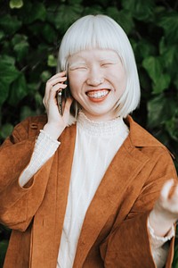 Cool and stylish albino girl talking on her phone