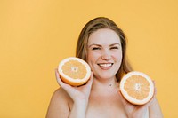 Blond woman holding two fresh oranges