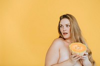 Confident plus size woman holding a cantaloupe