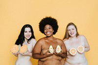 Diverse nude women holding fruits over their breasts