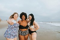 Beautiful confident women taking a selfie at the beach