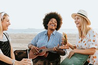 Friends singing together at a beach picnic