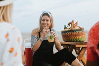 Woman drinking a mojito at a beach party