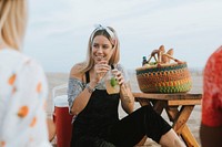 Woman drinking a mojito at a beach party