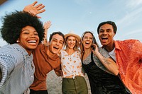 Group of diverse friends taking a selfie at the beach