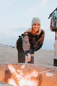 Woman roasting a marshmallow over a bonfire