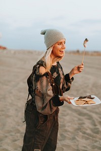 Woman having a s&#39;more at the beach