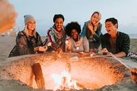 Friends roasting marshmallows to make s'mores