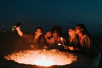 Friends roasting marshmallows over a bonfire