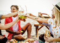 Diverse friends enjoying a beach picnic