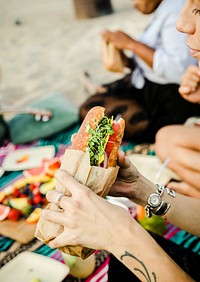 Woman eating a sandwich at the beach