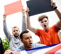 Group of angry men showing a UK flag and blank boards shouting during a protest
