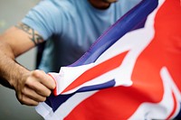 Close up of a man holding the flag of England