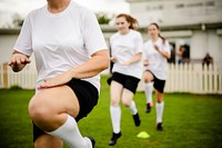Female football players warming up on the field