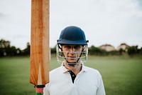 Cricket player holding a bat on the field