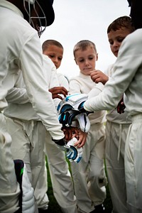 Young cricketer stacking their hands together
