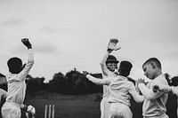 Young cricket players cheering for victory