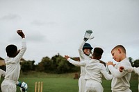 Young cricket players cheering for victory