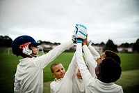 Group of young cricketers doing a high five