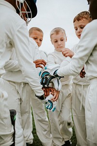 Young cricketer stacking their hands together
