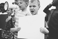 Young boy showing a blank paper in a protest