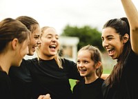 Cheerful female football players celebrating their victory