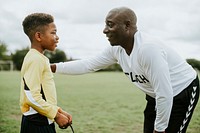 Football coach advising the goalkeeper