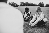 Young football kids stretching on the field