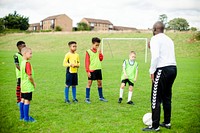 Football coach training his junior players