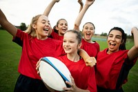 Energetic female rugby players celebrating
