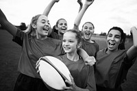 Energetic female rugby players celebrating