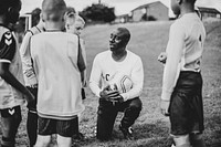 Football coach instructing his students