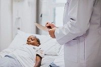 Pediatrician noting down symptoms of a patient