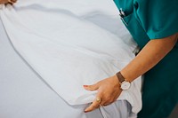 Nurse making the bed at a hospital