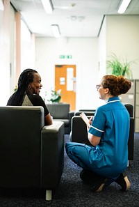 Nurse speaking to a patient in the waiting room