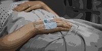 Coronavirus patient hand on an IV drip
