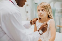 Pediatrician measuring the temperature of a young girl